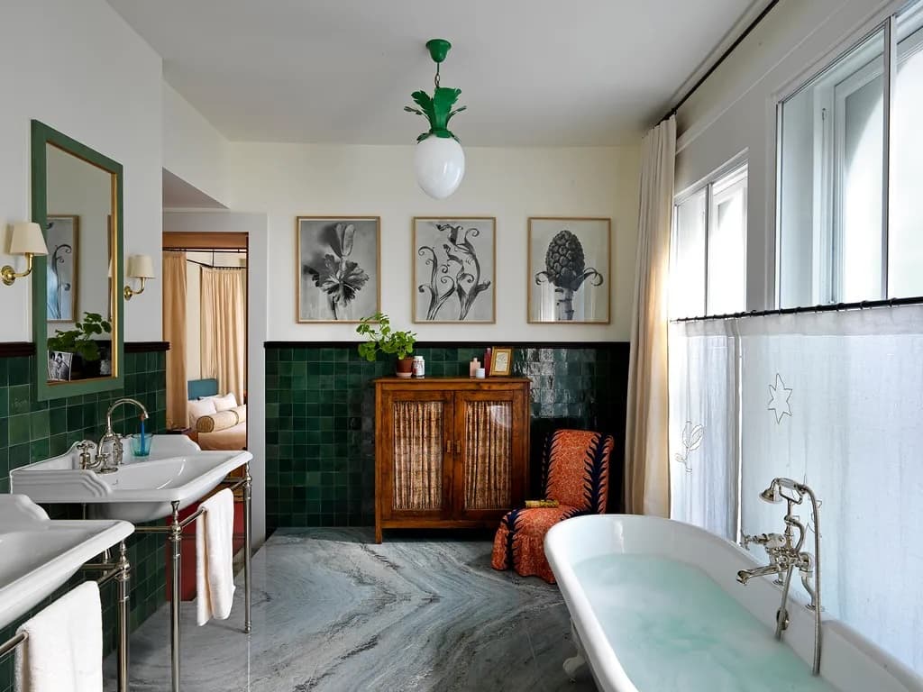 Restored bathroom with deep green tile and brass fixtures